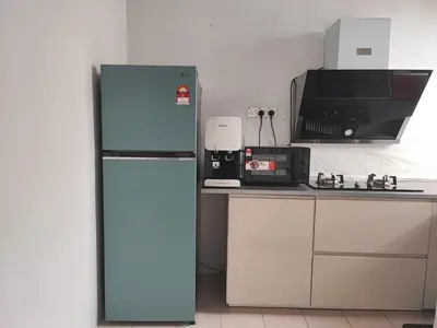 a blue refrigerator in a kitchen with a microwave at Homestay De' Humaira - USM Nibong Tebal in Nibung Tebal