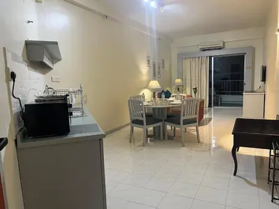 a kitchen and living room with a table and chairs at Paradise by the Sea in Penang by Veron at Rainbow Paradise in Tanjung Bungah
