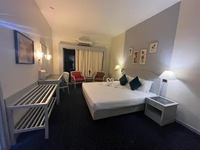a hotel room with a bed and a chair at Paradise by the Sea in Penang by Veron at Rainbow Paradise in Tanjung Bungah