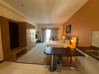 a hotel room with a bed and a desk at Paradise by the Sea in Penang by Veron at Rainbow Paradise in Tanjung Bungah