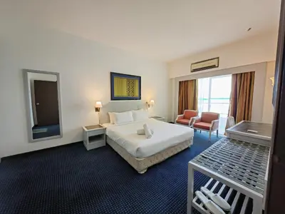 a hotel room with a bed and a television at Paradise by the Sea in Penang by Veron at Rainbow Paradise in Tanjung Bungah