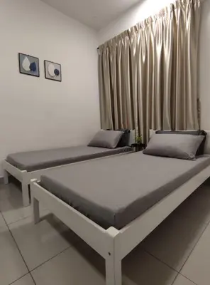 two beds sitting in a room with curtains at THE MAJESTIC IPOH B8 by ZamanJa in Ipoh