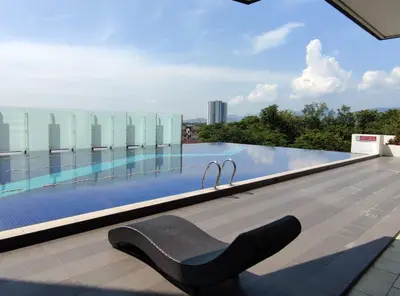 a chair on the roof of a building with a swimming pool at THE MAJESTIC IPOH B8 by ZamanJa in Ipoh