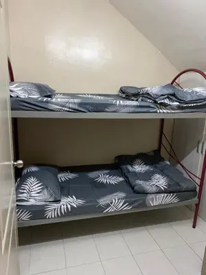 a bunk bed with blue sheets and pillows on it at Azzalea Homes 5 @ Golden Hills Cameron Highlands in Brinchang