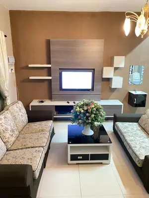 a living room with two couches and a tv at Azzalea Homes 5 @ Golden Hills Cameron Highlands in Brinchang