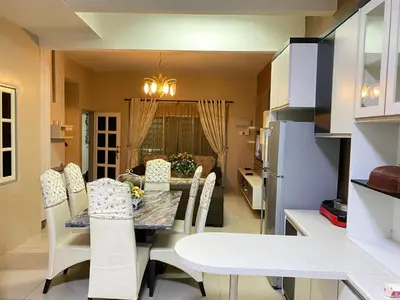 a kitchen and dining room with a table and chairs at Azzalea Homes 5 @ Golden Hills Cameron Highlands in Brinchang