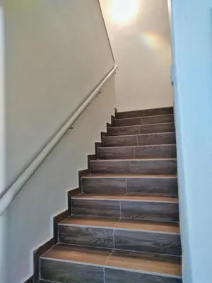 a staircase with wooden treads and a stair case at Semi-Detached, Up to 21 Pax, 4 Bedrooms, 3 Bathrooms, 4 Car Parks by Star Home in Bayan Lepas