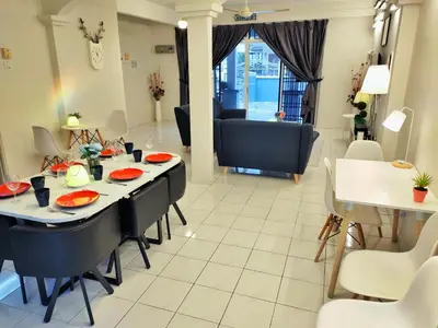 a dining room and living room with a table and chairs at Semi-Detached, Up to 21 Pax, 4 Bedrooms, 3 Bathrooms, 4 Car Parks by Star Home in Bayan Lepas