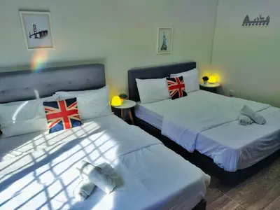 a room with two beds with british flags on them at Semi-Detached, Up to 21 Pax, 4 Bedrooms, 3 Bathrooms, 4 Car Parks by Star Home in Bayan Lepas