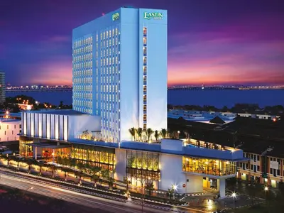 a large building with a lit up facade at night at Semi-Detached, Up to 21 Pax, 4 Bedrooms, 3 Bathrooms, 4 Car Parks by Star Home in Bayan Lepas