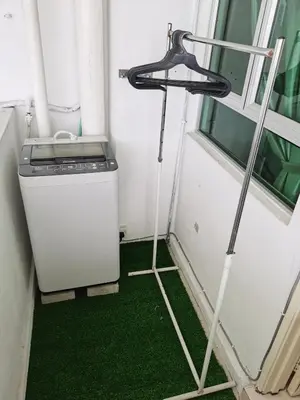 a washer and dryer in a room next to a window at TuR11-Oppesite Pisa Stadium-1min-FoodCourt-MiniMarket in Bayan Lepas