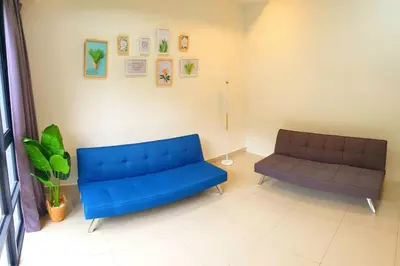 a living room with a blue couch and a chair at ●SSV10●4pax●Comfort House●13minit●Airpot●CondoPool in Bayan Lepas