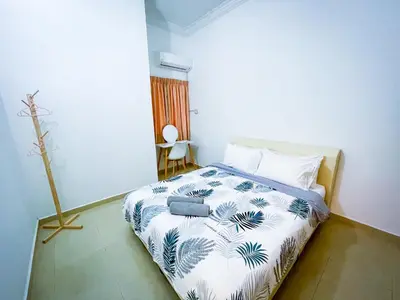 a bedroom with a bed with a blue and white spread at Tupai Mas Semi-D 4BR 2mins to LakeGarden & Zoo in Taiping