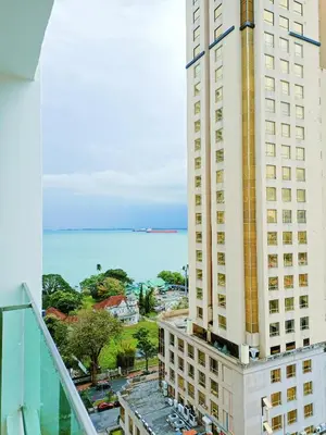 a view of the ocean from the balcony of a building at Mansion One Two Bedroom Seaview 7 Pax in George Town