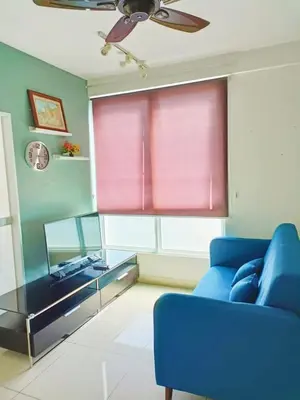 a living room with a blue couch and a window at Mansion One Two Bedroom Seaview 7 Pax in George Town