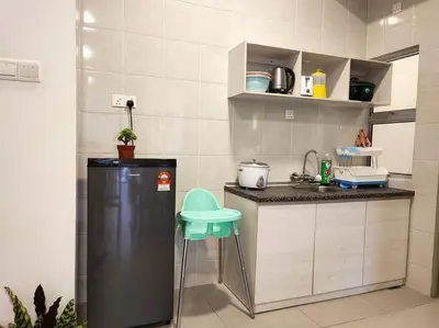 a small kitchen with a refrigerator and a sink at W39C WarmStay atGoldenHill NightMarket 2R WiFi CarPark in Brinchang