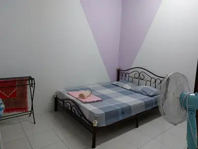 a small bedroom with a bed with a hat on it at Pelangi homestay in Kampung Bota Kiri