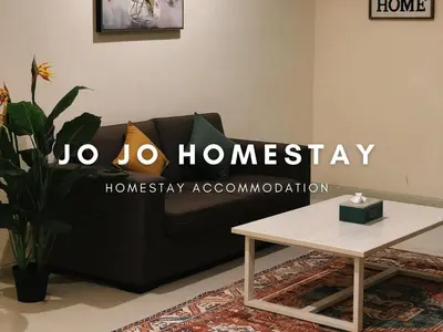 a black couch in a living room with a table at Jo Jo Homestay @ Marina Island Laguna in Lumut