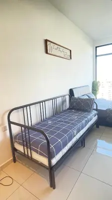 a bed in a room with a sign on the wall at Beacon Executive Suite at Georgetown for 10pax and 2 BED ROOM in George Town