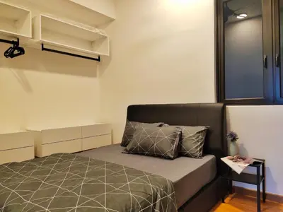 a small bedroom with a bed and a window at Beacon Executive Suite at Georgetown for 10pax and 2 BED ROOM in George Town