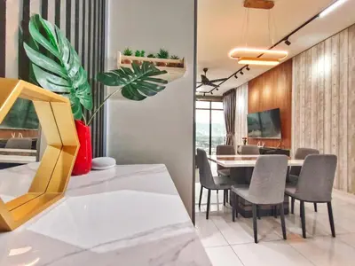 a dining room and living room with a table and chairs at Beacon Executive Suite at Georgetown for 10pax and 2 BED ROOM in George Town