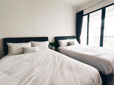 two beds sitting next to each other in a bedroom at The Landmark by Katana 3BR to 4BR Luxury Seaview Landmark Homestay at Gurney 15-16pax \u65e0\u654c\u6d77\u666f\u5957\u623f in Tanjong Tokong