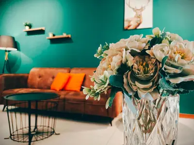 a vase of flowers in a living room with a couch at The Landmark by Katana 3BR to 4BR Luxury Seaview Landmark Homestay at Gurney 15-16pax \u65e0\u654c\u6d77\u666f\u5957\u623f in Tanjong Tokong