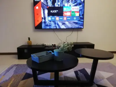 a living room with a table and a tv on the wall at The Landmark by Katana 3BR to 4BR Luxury Seaview Landmark Homestay at Gurney 15-16pax \u65e0\u654c\u6d77\u666f\u5957\u623f in Tanjong Tokong