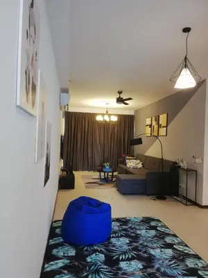 a living room with a blue ottoman on the floor at The Landmark by Katana 3BR to 4BR Luxury Seaview Landmark Homestay at Gurney 15-16pax \u65e0\u654c\u6d77\u666f\u5957\u623f in Tanjong Tokong