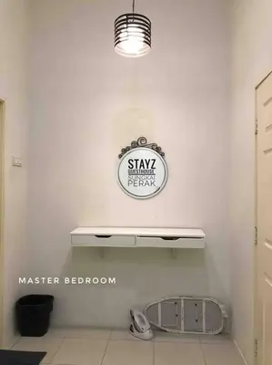 a shelf in a room with a sign on the wall at Stayz Guesthouse in Sungkai