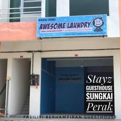 a building with a sign on the side of it at Stayz Guesthouse in Sungkai