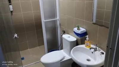 a bathroom with a toilet and a sink and a shower at Mysa Homestay in Kampong Batu Dua