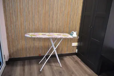 a table with a flowered seat in a room at MARITIME SUITE DUPLEX PENANG- PEMANDANGAN LAUT in George Town