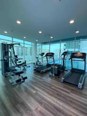 a gym with several treadmills and elliptical machines at MARITIME SUITE DUPLEX PENANG- PEMANDANGAN LAUT in George Town