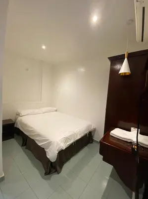 a small bedroom with a bed and a desk at HOTEL MIRAMA \u7f8e\u9e97\u83ef\u9152\u5e97 in Sitiawan
