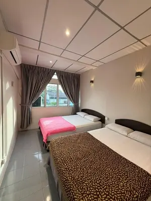 a bedroom with two beds and a window at HOTEL MIRAMA \u7f8e\u9e97\u83ef\u9152\u5e97 in Sitiawan