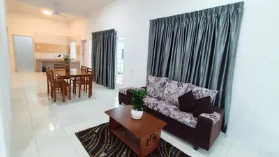 a living room with a couch and a table at Malim Nawar holiday house in Malim Nawar