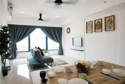 a living room with a table and a chair at The GRANDE @ Tropicana 218 Macalister in George Town