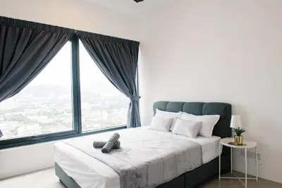 a bedroom with a bed with a large window at The GRANDE @ Tropicana 218 Macalister in George Town