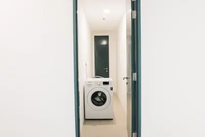 a bathroom with a washing machine in a room at The GRANDE @ Tropicana 218 Macalister in George Town