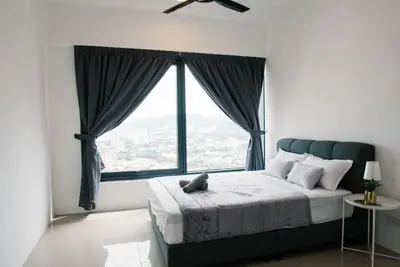 a bedroom with a bed and a large window at The GRANDE @ Tropicana 218 Macalister in George Town