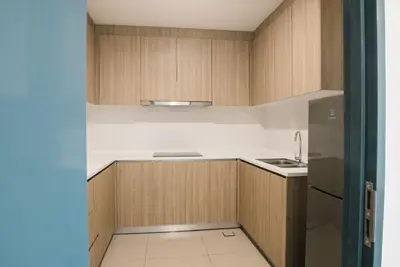 a kitchen with wooden cabinets and a sink at The GRANDE @ Tropicana 218 Macalister in George Town