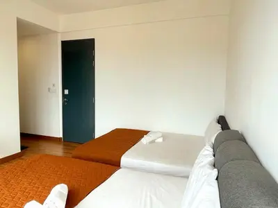 a bedroom with a bed and a blue door at The GRANDE @ Tropicana 218 Macalister in George Town