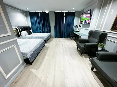 a hotel room with two beds and a desk at 61 Hotel in Gua Musang