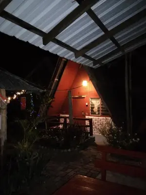 a night view of a patio with awning at Nazri Nipah Camp Pangkor in Kampung Teluk Nipah