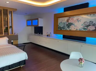 a hotel room with a bed and a flat screen tv at King's Lane Ipoh in Ipoh