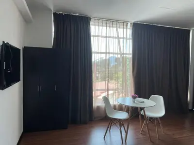 a room with a table and chairs and a window at King's Lane Ipoh in Ipoh