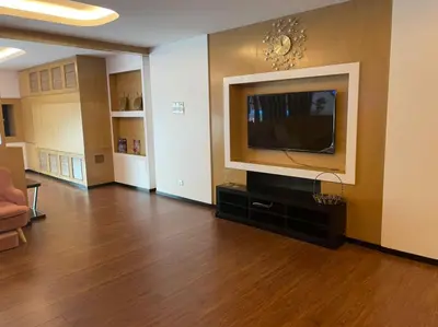 a living room with a flat screen tv on a wall at King's Lane Ipoh in Ipoh