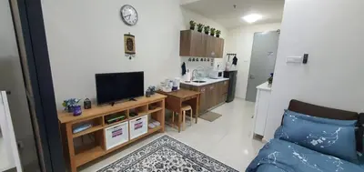 a living room with a couch and a tv and a kitchen at Hannah suite at cameronfair in Cameron Highlands