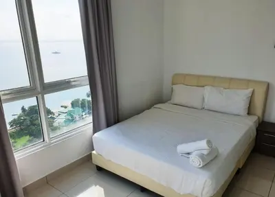 a bed in a room with a large window at Mansion One 3 Bedroom SEAVIEW Gurney Georgetown 1-13Pax in George Town